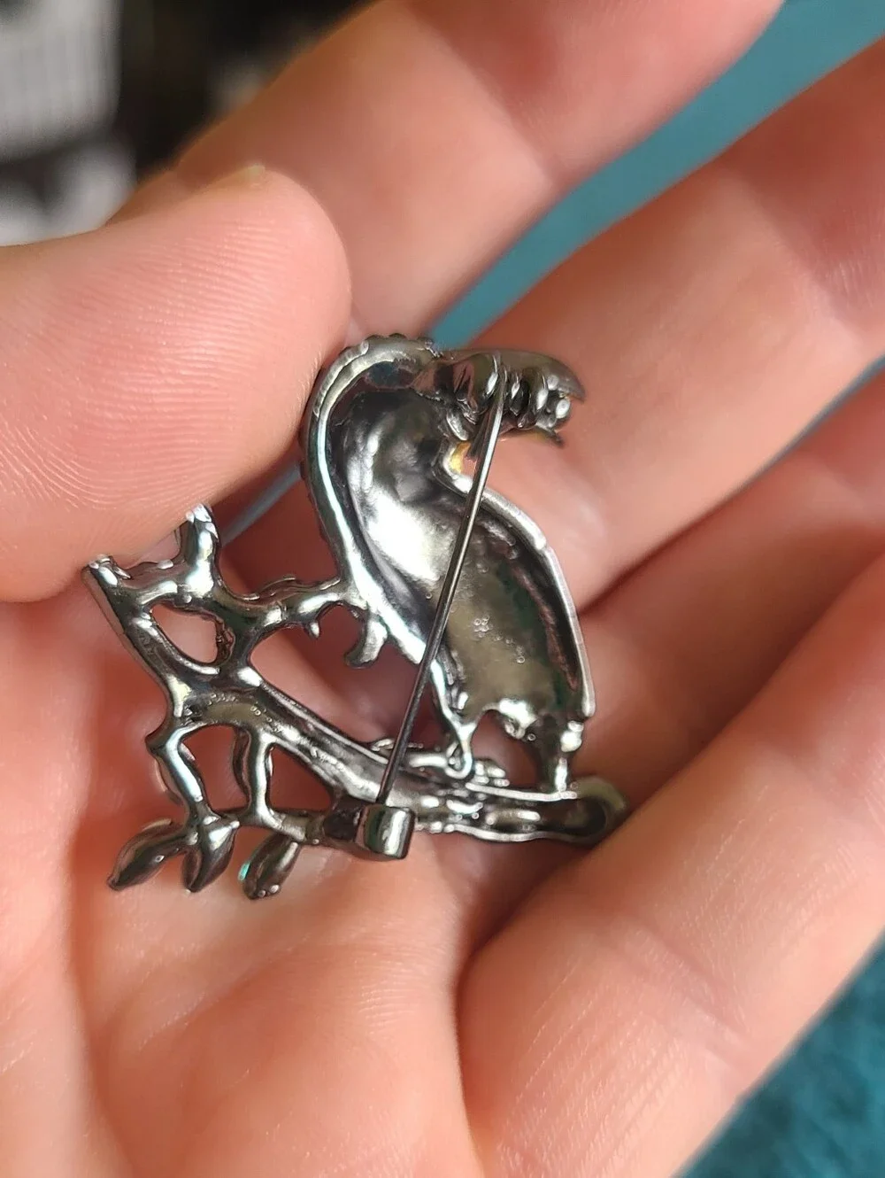 Vintage Gold-Accented Black Toucan Brooch with Green Leaves
